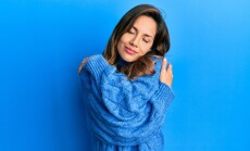 Young,Latin,Woman,Wearing,Casual,Winter,Sweater,Hugging,Oneself,Happy