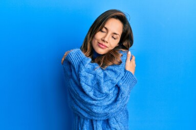 Young,Latin,Woman,Wearing,Casual,Winter,Sweater,Hugging,Oneself,Happy