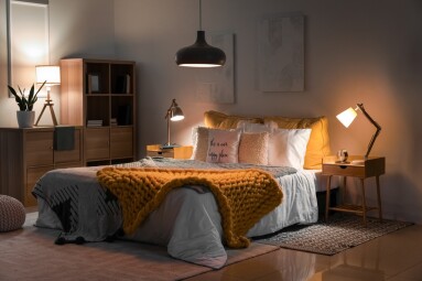 Interior,Of,Bedroom,With,Knitted,Plaid,On,Bed,And,Glowing