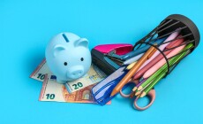 Piggy,Bank,,Money,And,Holder,With,Different,School,Stationery,On