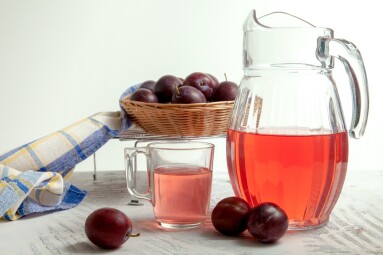 Plum,Compote,In,Jug,And,Cup,With,Several,Ripe,Sweet