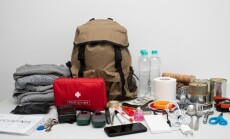 Emergency,Backpack,Equipment,Organized,On,The,Table.,Documents,,Water,food,,First