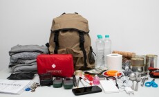 Emergency,Backpack,Equipment,Organized,On,The,Table.,Documents,,Water,food,,First