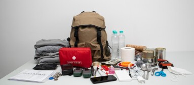 Emergency,Backpack,Equipment,Organized,On,The,Table.,Documents,,Water,food,,First