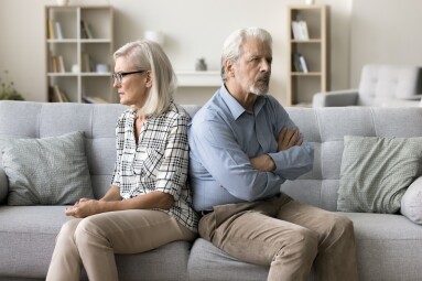 Annoyed,Ignoring,Senior,Couple,Sitting,On,Home,Couch,Back,To