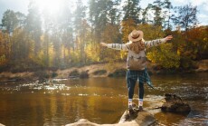 Beautiful,Woman,Traveler,Enjoying,Autumn,Hiking,Along,The,River.,A