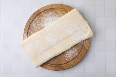 Raw,Puff,Pastry,Dough,On,White,Tiled,Table,,Top,View