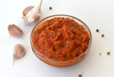 Bowl,Of,Red,Sauce,,Close-up,garlic,On,A,White,Background.,Homemade