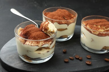 Delicious,Tiramisu,In,Glasses,,Spoon,And,Coffee,Beans,On,Black