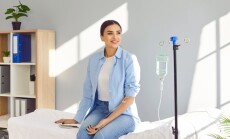 Young,Happy,Smiling,Woman,Sitting,On,The,Couch,In,Medical