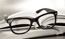 A,Pile,Of,Books,And,Glasses,Symbolizing,The,Concept,Of