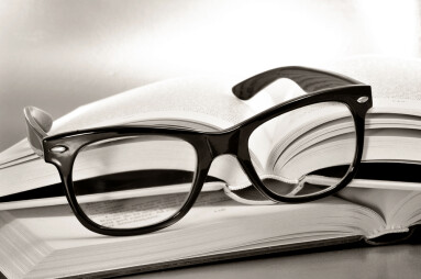 A,Pile,Of,Books,And,Glasses,Symbolizing,The,Concept,Of