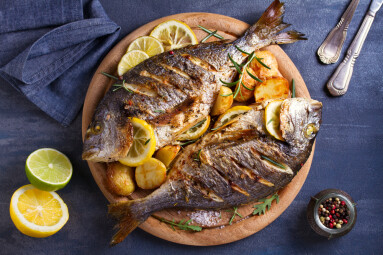 Grilled,Fish,With,Roasted,Potatoes,,Lemon,And,Rosemary,On,Wooden