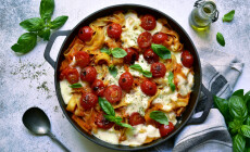 Pasta,Casserole,With,Tomatoes,And,Mozzarella,Cheese,In,A,Black