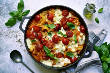 Pasta,Casserole,With,Tomatoes,And,Mozzarella,Cheese,In,A,Black