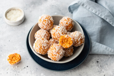 Apricot,Coconut,Bliss,Balls,In,Blue,Bowl,On,Gray,Background.