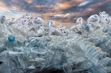 Plastic,Problem,,A,Mountain,Of,Plastic,Bottles,Against,The,Sky.