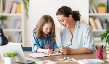 Happy,Child,And,Adult,Are,Sitting,At,Desk.,Girl,Doing