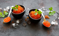 Red,Caviar,In,Bowls,On,A,Old,Black,Background