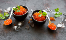 Red,Caviar,In,Bowls,On,A,Old,Black,Background