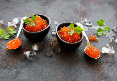 Red,Caviar,In,Bowls,On,A,Old,Black,Background