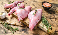 Raw,Rabbit,Legs,On,A,Cutting,Board.,Wooden,Background.,Top