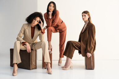 Full,Length,Of,Stylish,Multicultural,Women,In,Suits,Sitting,On