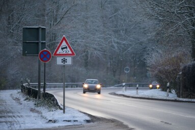 Cars,Driving,Down,A,Wet,Mountain,Road,In,Winter,With