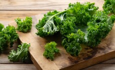 Cutting,Board,And,Kale,On,Wooden,Background.,Curly,Kale.,Close-up.