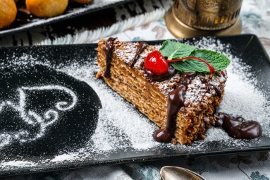 Waffle,Cake,With,Condensed,Milk,And,Chocolate,On,Wooden,Background.