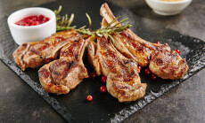 Grilled,Lamb,Chops,With,Cranberries,And,Rosemary,On,Natural,Black