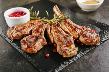 Grilled,Lamb,Chops,With,Cranberries,And,Rosemary,On,Natural,Black