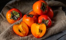 Ripe,Persimmon,On,Wooden,Background.,Date-plum,Or,Sharon,Fruit.,Kaki