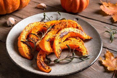 Roasted,Pumpkin,Slices,With,Garlic,And,Herbs,Close,Up.,Oven