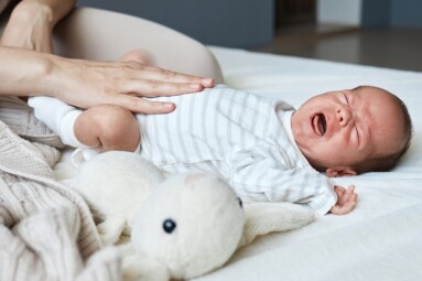 Unrecognizable,Woman,Massaging,Tummy,Of,Her,Crying,Sick,Son,Trying