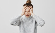 Exhausted,Young,Woman,Touching,Her,Head,With,Eyes,Closed.,Female