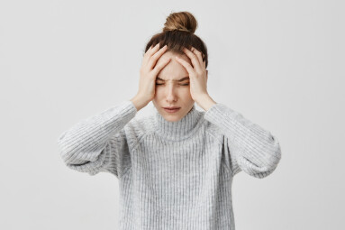 Exhausted,Young,Woman,Touching,Her,Head,With,Eyes,Closed.,Female