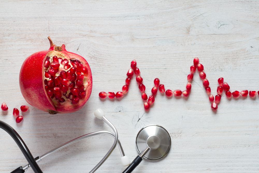 Fruit,Pomegranate,,Stethoscope,And,Ecg,Cardiogram,From,Pomegranate,Seeds,,Healthy