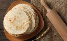 Many,Tasty,Homemade,Tortillas,And,Rolling,Pin,On,Wooden,Table,