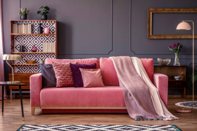 Front,View,Of,A,Pink,Sofa,With,Pillows,And,Blanket,