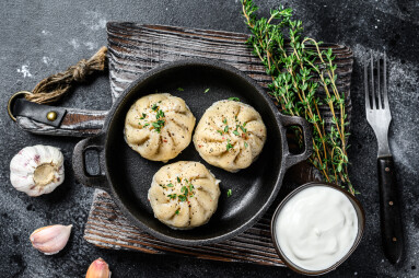 Asian,Steamed,Dumplings,Manti,In,A,Pan.,Black,Background.,Top