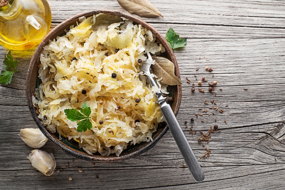 Homemade,Sauerkraut,With,Black,Pepper,And,Parsley,In,Wooden,Bowl