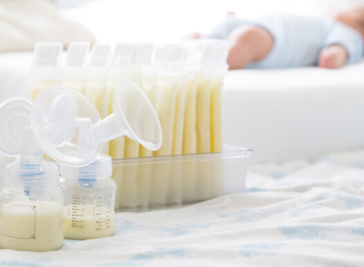 Breast,Milk,Frozen,In,Storage,Bag,And,Baby,Lying,On
