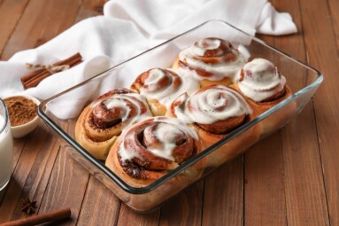 Baking,Dish,Of,Tasty,Cinnamon,Rolls,With,Cream,On,Wooden