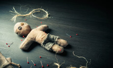 Voodoo,Doll,On,A,Wooden,Background,With,Dramatic,Lighting