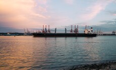 Cargo ship parked at the harbor on a sunny day during sunset