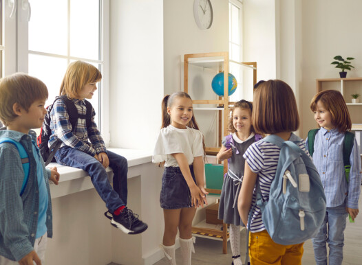 Bunch,Of,Kids,With,School,Bags,Standing,In,The,Classroom