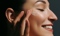 Enjoying,Young,Woman,Applying,Moisturizer,On,Her,Face.,Daily,Skin