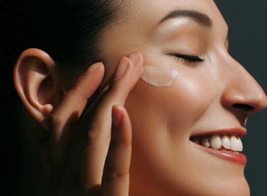Enjoying,Young,Woman,Applying,Moisturizer,On,Her,Face.,Daily,Skin