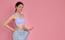 Happy,Young,Woman,In,Big,Jeans,Showing,Her,Slim,Body